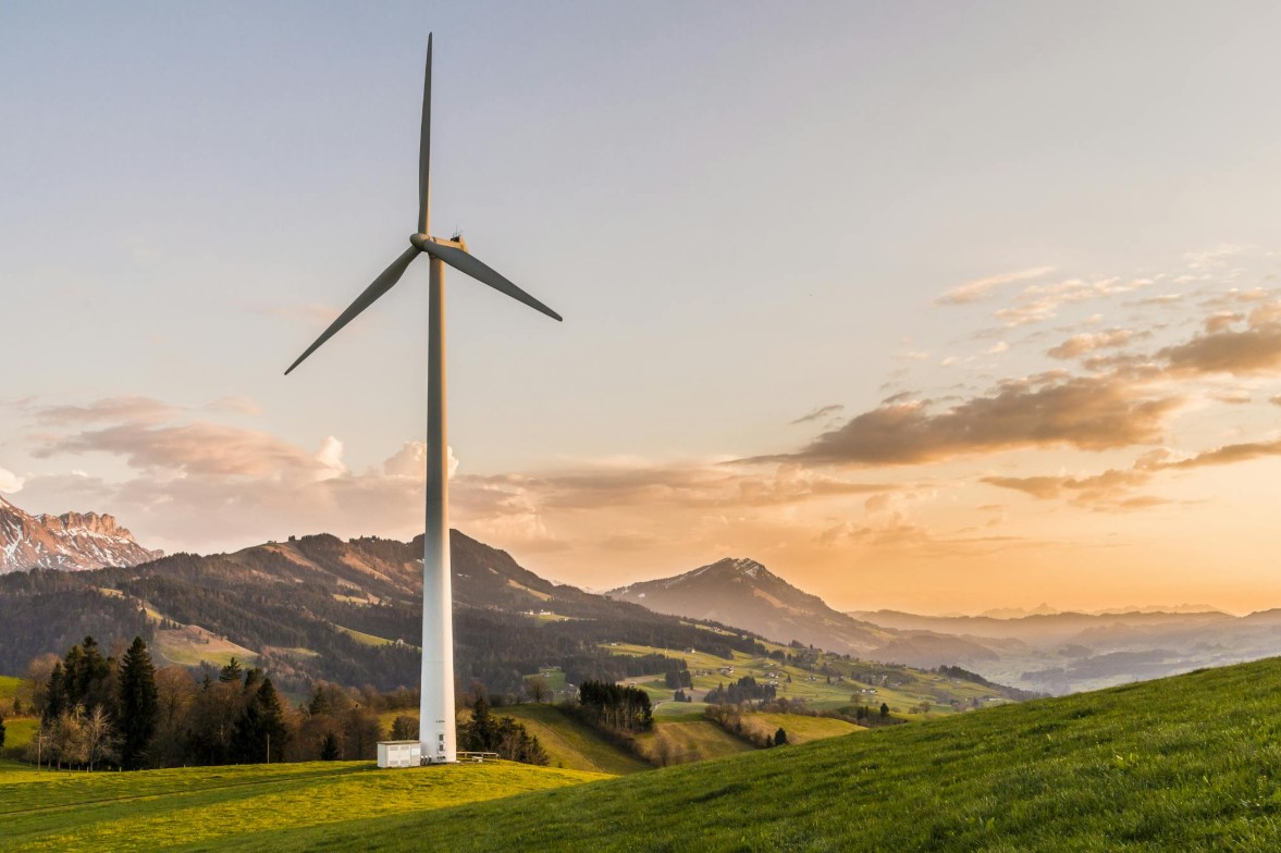 a wind turbine transfers energy from __________ energy store. what one word completes the sentence